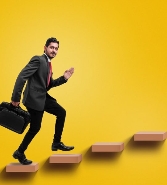 Young indian businessman climbing the stairs,Concept of success and achieving your goal. Mock up