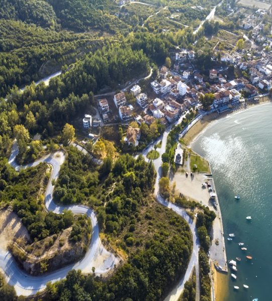 Aerial drone view of blue sea and windy mountain roads in Halkidiki, Greece